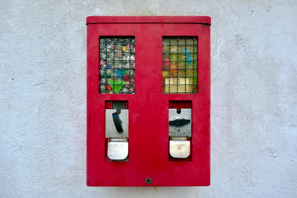 old chewing gum automat on a wall